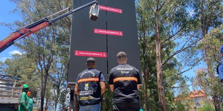 Equipes da Fiscalização realizam corte de energia e afixação de adesivos de "Publicidade Irregular" em painel sem licença na BR-356, em operação nesta sexta-feira (14) (Divulgação/PBH)